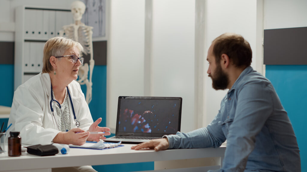 Clinician speaking with a patient during a consultation